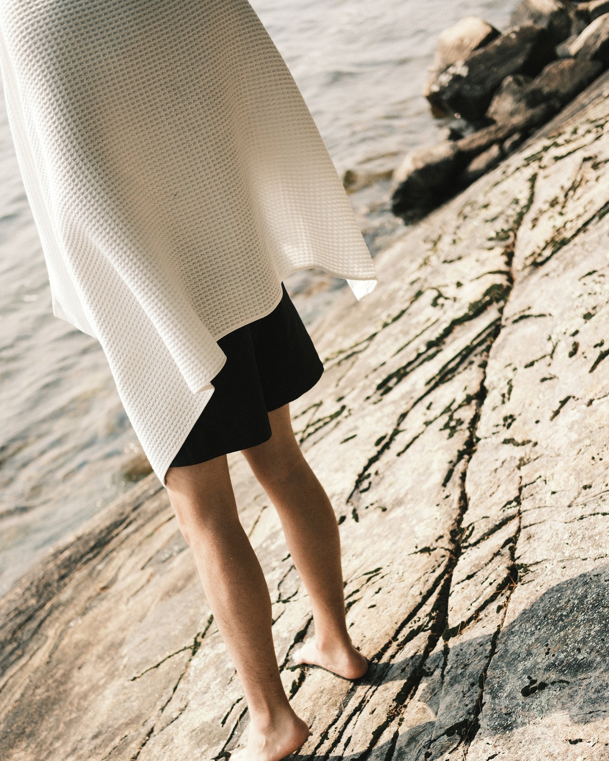 Person drying with a Nossara Imabari Towel in a lake near Kyoto